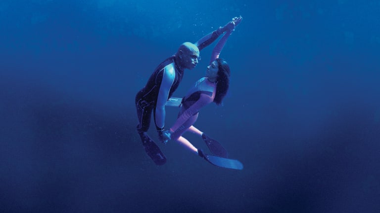 Nude couples scuba diving