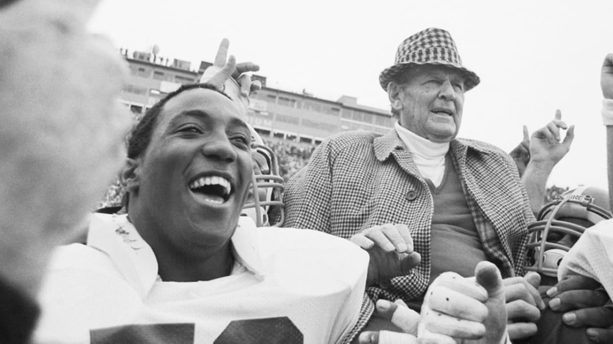 Signed photograph of Coach Paul Bear Bryant leaning against the