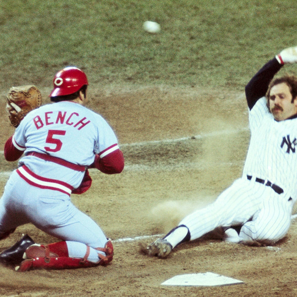 Thurman Munson tries to score while Johnny Bench blocks home plate during  the 1976 World Series game at Yankee Stadium.