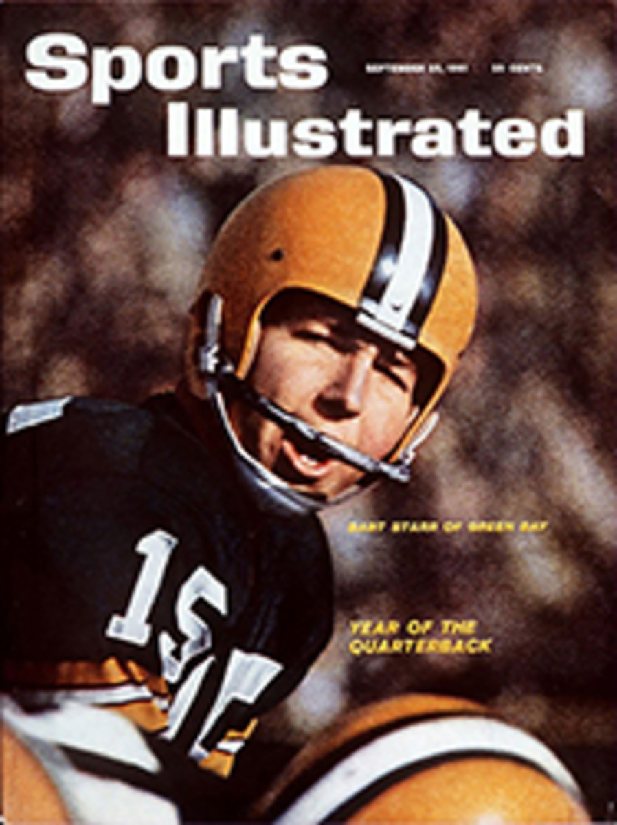 Quarterback Cotton Davidson of the Dallas Texans hands the ball