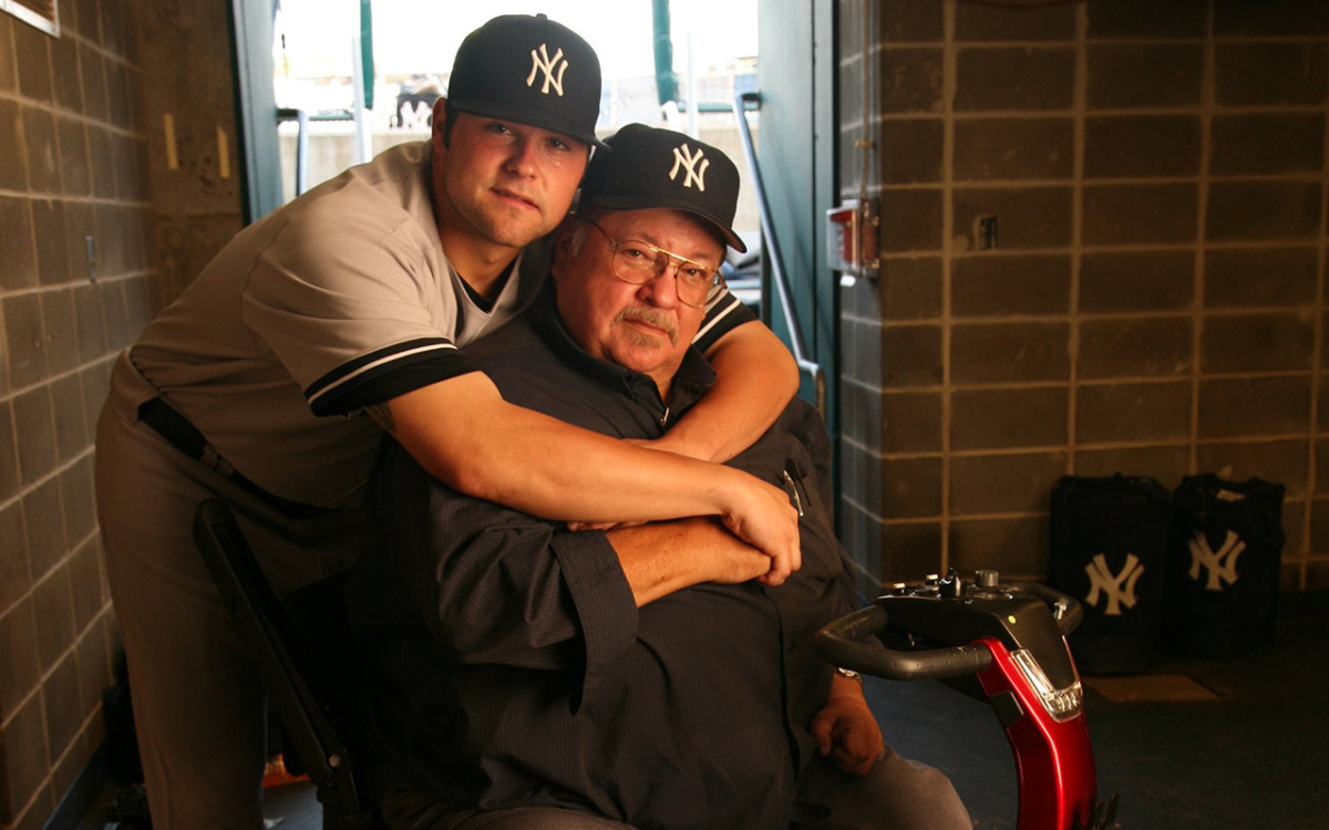 New York Yankees' pitcher Joba Chamberlain hugs his father Harlan