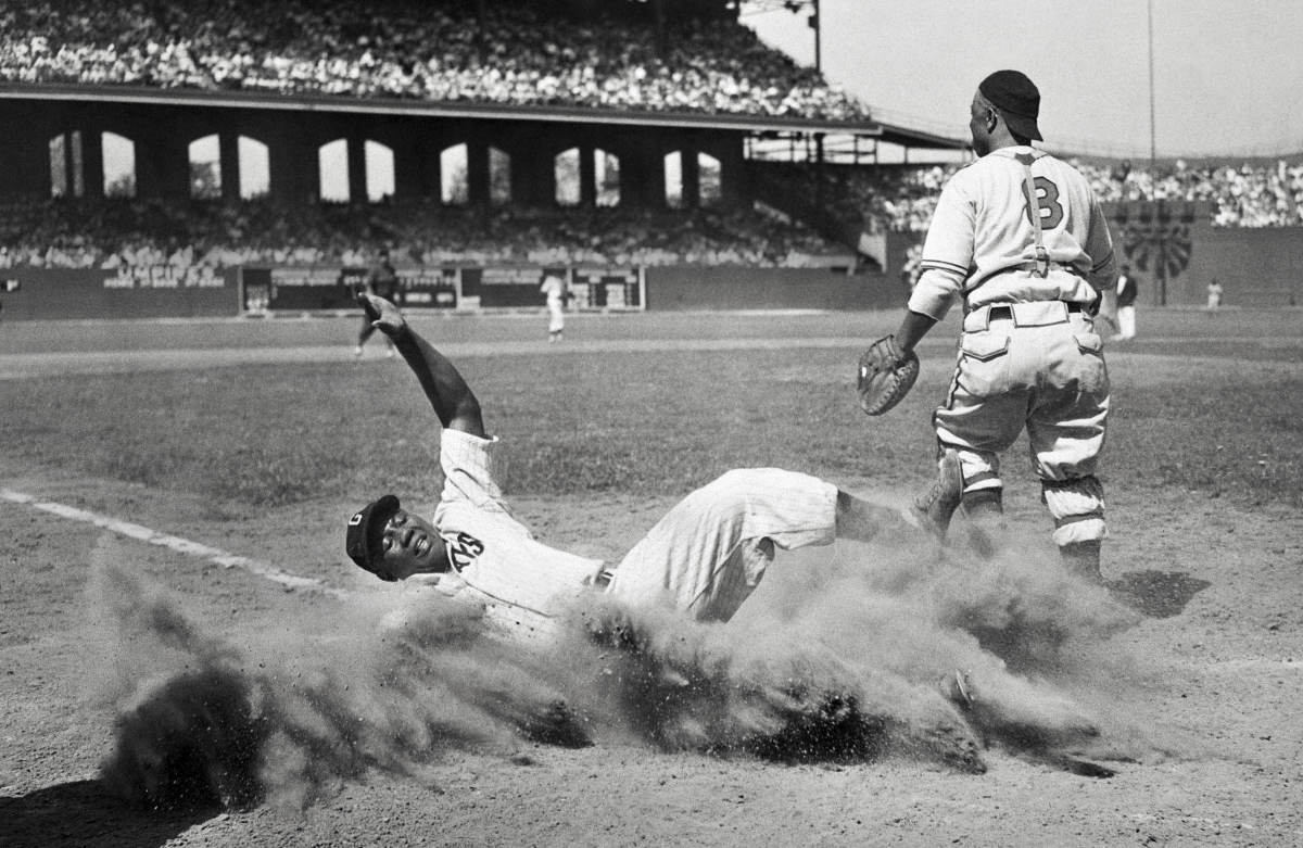 ELECTRIC SLIDE
Josh Gibson (crossing the plate during a Negro leagues All-Star Game in 1944) may well be the best power-hitting catcher—any league, any era. He was known as the Black Babe Ruth, though some who saw him play refer to the Bambino as the white Josh Gibson.
